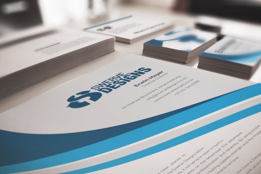 Corporate Identity And Corporate Branding. Letterhead And Business Cards On White Table